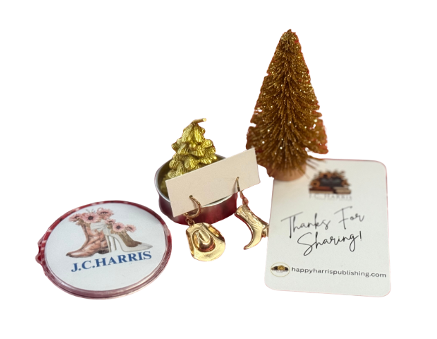 https://happyharrispublishing.com/ Small decorative items including a gold Christmas tree, gold Christmas tree candle, gold earrings, gold Christmas tree and a badge with 'J.C HARRIS'